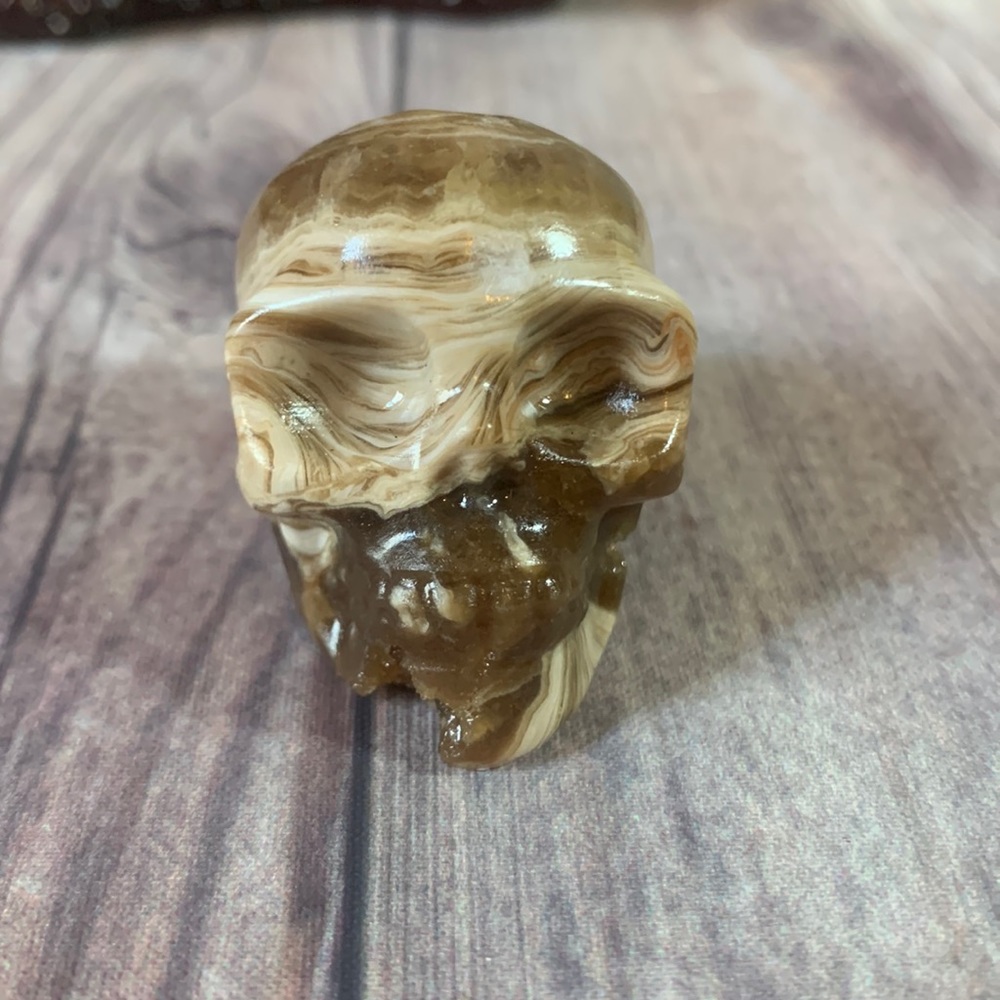 Amber calcite skull carving.